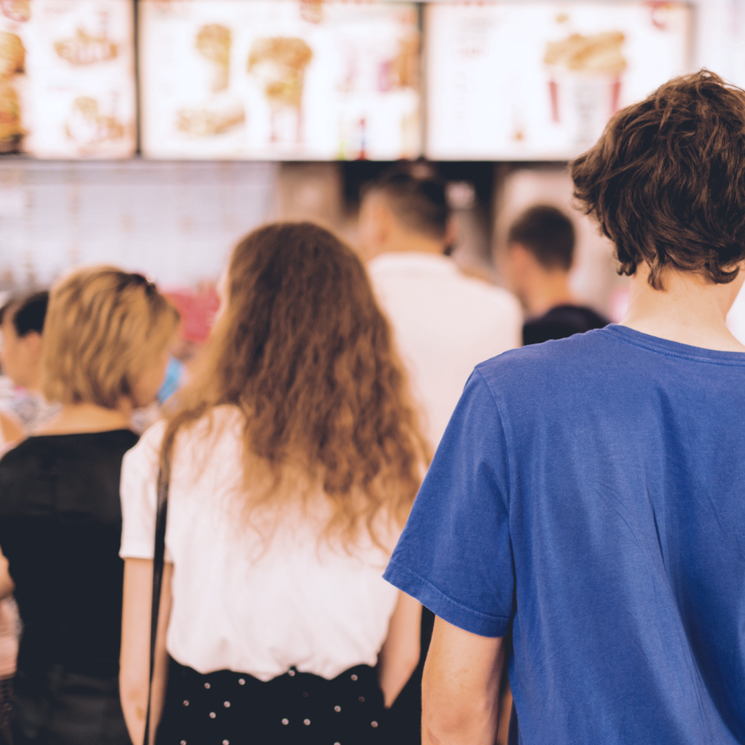 People waiting in line at a quick-service restaurant.